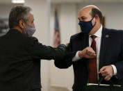 State Rep. Cory Maloy, R-Lehi, left, congratulates Rep. Walt Brooks, R-St. George, after members of the House Judiciary Standing Committee passed Brooks' bill, HB60, at the Capitol in Salt Lake City, Friday, Jan. 22, 2021. HB60 would remove the state's requirement for law-abiding Utahns over the age of 21 to have a permit to lawfully carry a concealed firearm. (Laura Seitz/The Deseret News via AP)