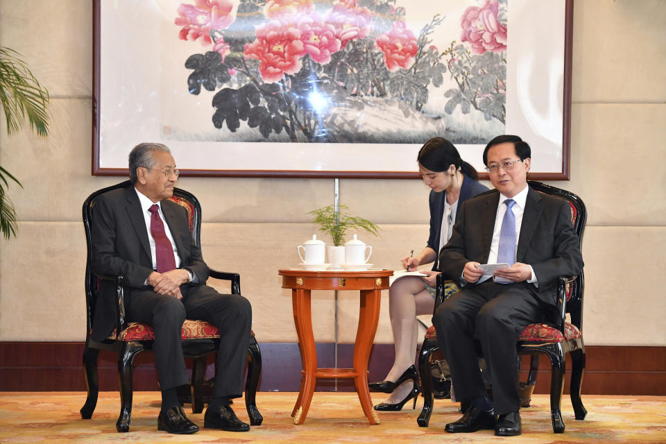 Malaysian Prime Minister Mahathir Mohamad, left, attends a meeting with Che Jun, the Communist Party chief of Zhejiang Province, right, in Hangzhou in eastern China's Zhejiang Province, Saturday, Aug. 18, 2018. Mahathir is making a five-day visit to China at a time when ties between Beijing and the Southeast Asian nation are being tested by the Malaysian leader's suspension of multibillion-dollar Chinese-backed infrastructure projects. (Chinatopix via AP)