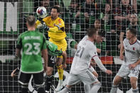 St Louis City SC goalkeeper Roman Burki, top left, blocks a shot on goal by Austin FC during the first half of an MLS soccer match in Austin, Texas, Saturday, Feb. 25, 2023. (AP Photo/Eric Gay)