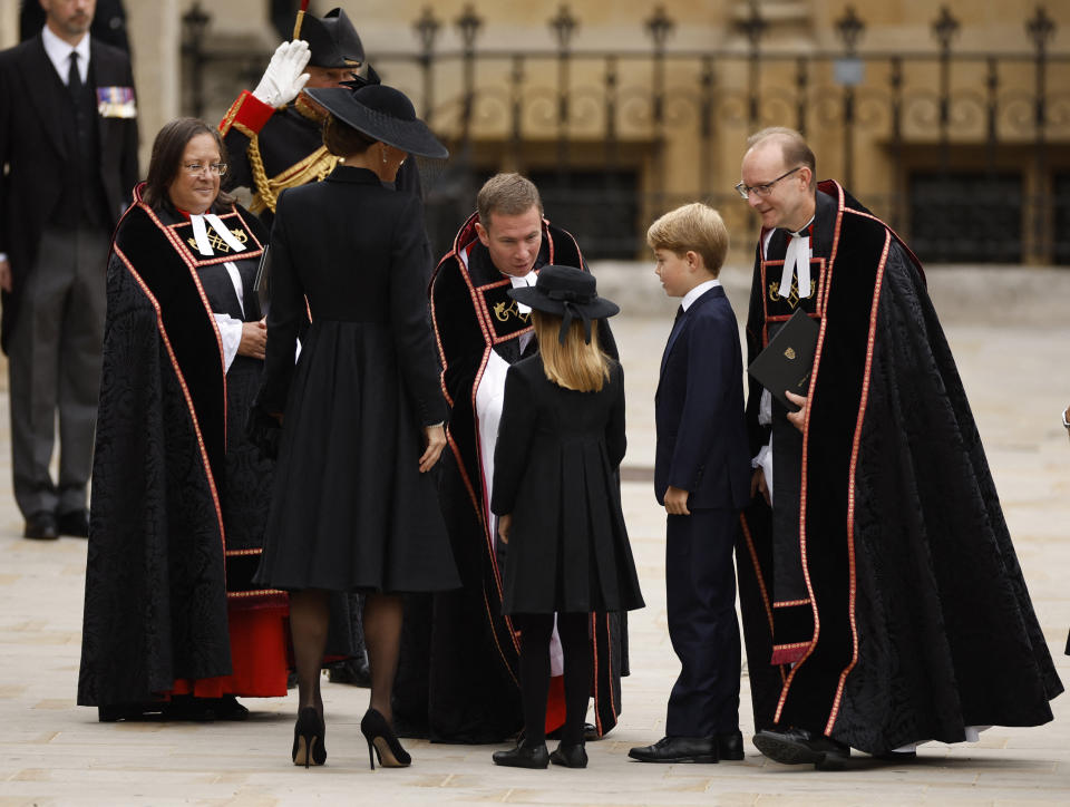<p>Britain's Catherine, Princess of Wales, Britain's Princess Charlotte and Britain's Prince George are greeted by The Reverend Jamie Hawkey, The Right Reverend Anthony Ball and The Venerable Patricia Hillas outside Westminster Abbey on the day of state funeral and burial of Britain's Queen Elizabeth, in London, Britain, September 19, 2022 REUTERS/John Sibley</p> 