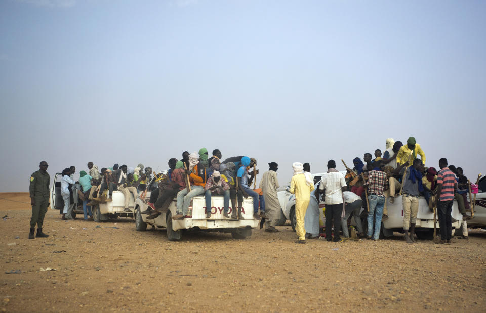 File-This June 14, 2018, file photo shows Nigeriens and third-country migrants head towards Libya from Agadez, Niger. The U.N. humanitarian chief, Mark Lowcock, is hoping a major ministerial meeting on Tuesday, Oct. 20, 2020, will not only raise a billion dollars for the three countries at the epicenter of a humanitarian crisis in Africa’s Sahel region -- Burkina Faso, Mali, and Niger -- but spur leaders to address the underlying drivers including increasing conflict and insecurity, weak governance, and a lack of development. (AP Photo/Jerome Delay)