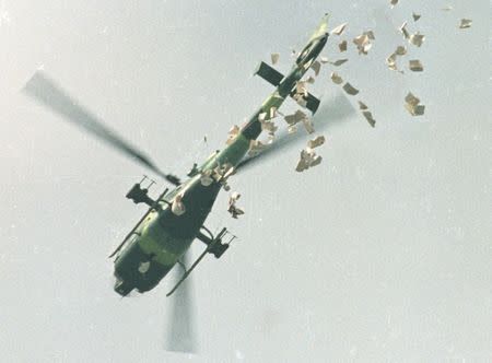 FILE PHOTO: A military helicopter drops leaflets above Tiananmen Square in Beijing, China, May 22, 1989, which state that the student protesters should leave the Square as soon as possible on Monday morning. REUTERS/Shunsuke Akatsuka/Files