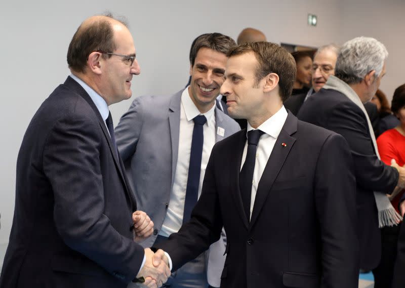 FILE PHOTO: French President Emmanuel Macron shakes hands with Interministerial Delegate for the Olympic and Paralympic Games 2024 Jean Castex flanked by President of the Paris Organising Committee of the 2024 Olympic and Paralympic Games Tony Estanguet in