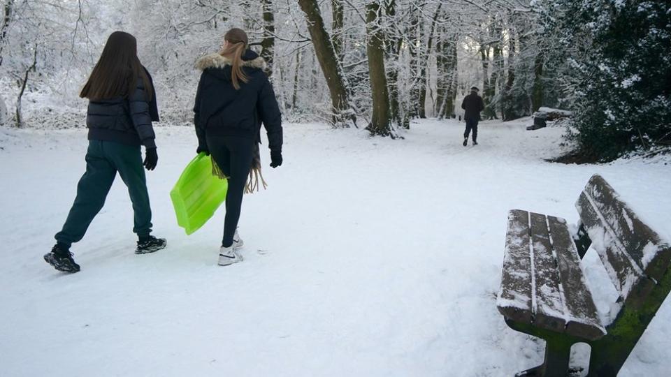 People with sledges make their way to Camp Hill in Woolton, Liverpool.