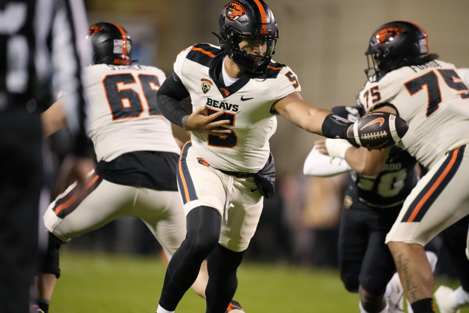 Oregon State quarterback DJ Uiagalelei hands the ball off during the first half of the tem's NCAA college football game against Colorado on Saturday, Nov. 4, 2023, in Boulder, Colo. (AP Photo/David Zalubowski)