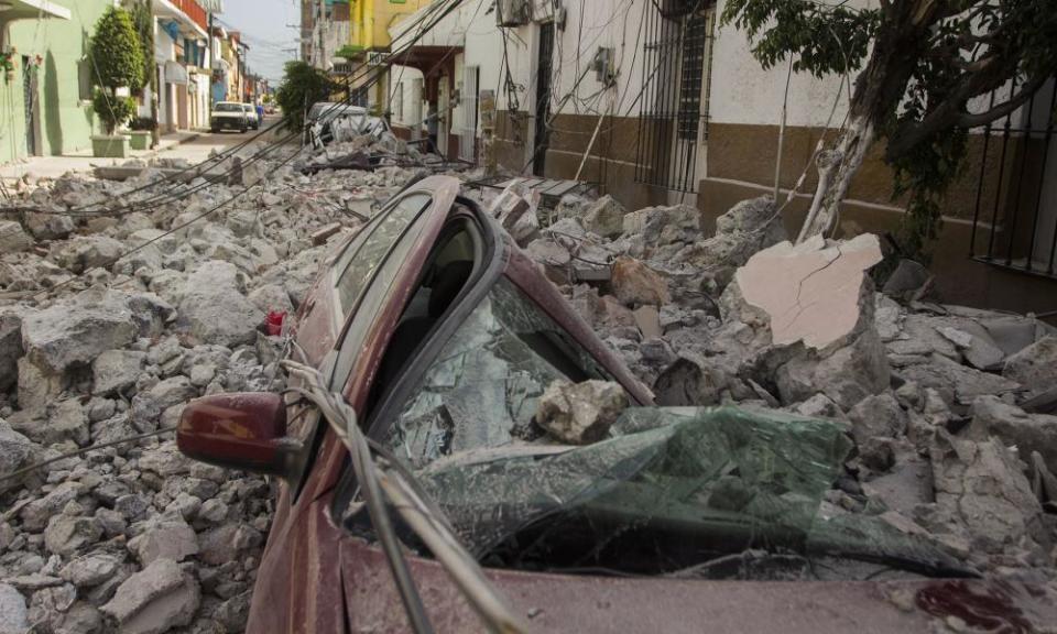 A car crushed by debris from damaged houses in Jojutla de Juarez, Mexico, on 20 September 2017.