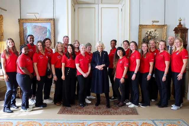 <p>CHRIS JACKSON/POOL/AFP via Getty</p> Queen Camilla (center) hosts the Maiden yachting crew at Clarence House in London on April 29, 2024.