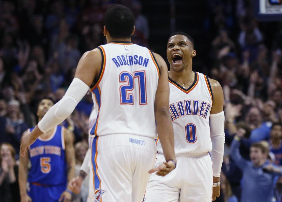 Oklahoma City Thunder guard Russell Westbrook (0) celebrates with forward Andre Roberson (21) after a basket by Roberson during the second quarter of the team's NBA basketball game against the New York Knicks in Oklahoma City, Wednesday, Feb. 15, 2017. (AP Photo/Sue Ogrocki)