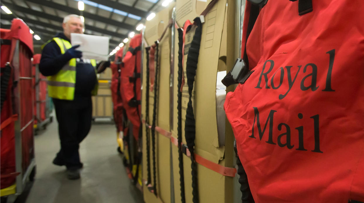 Embargoed to 0001 Monday December 3. A Royal Mail employee at work at a dedicated Christmas parcel sorting centre in at a Royal Mail depot in Lanarkshire, Scotland.