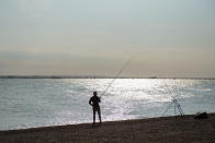 SOUTHEND-ON-SEA, ENGLAND - SEPTEMBER 20: A man fishes as the sun goes down during recent warm weather on September 20, 2020 in Southend on Sea, London. (Photo by John Keeble/Getty Images)