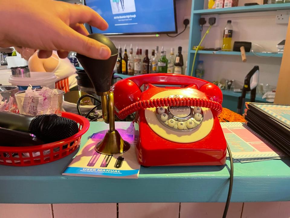 A comedy horn next to a telephone at Karen's Diner
