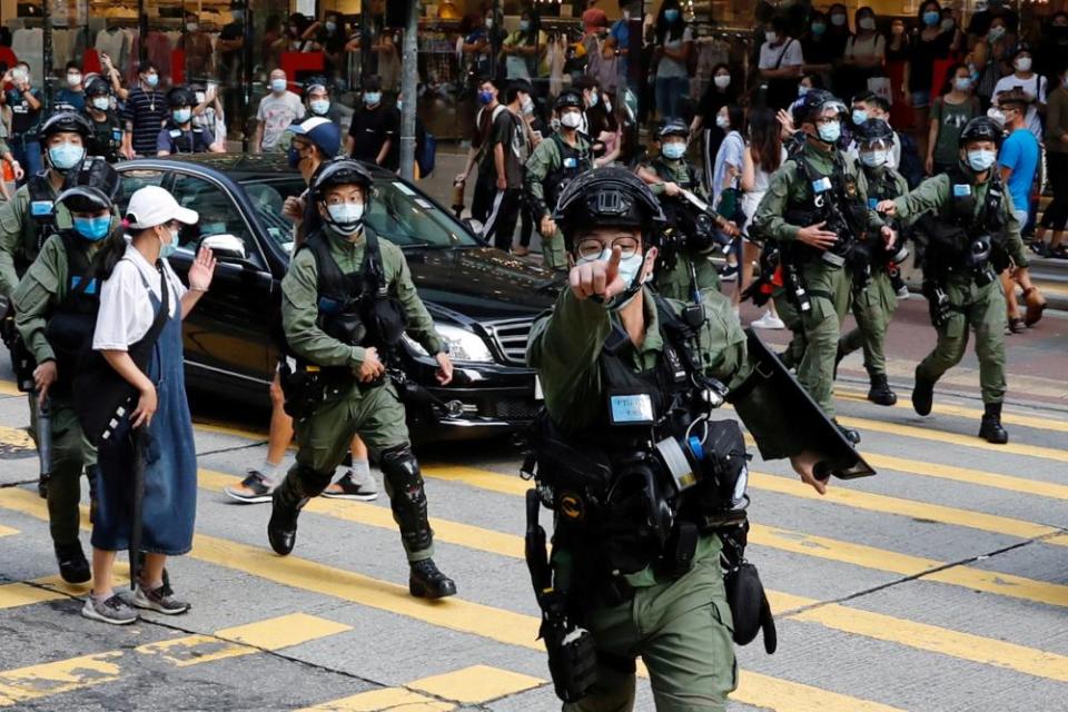 Riot police chase pro-democracy protesters during a demonstration in Hong Kong, September 2020