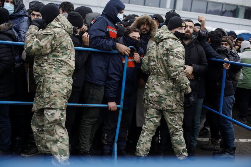 Migrants wait to receive food near the Belarusian-Polish border in the Grodno region