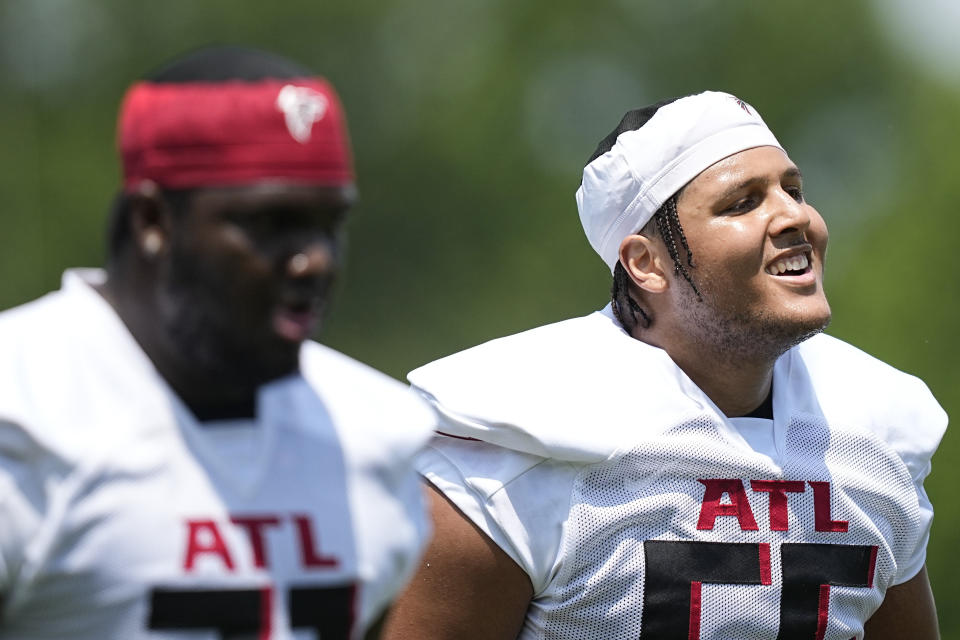 Atlanta Falcons offensive lineman Matthew Bergeron, right, runs drills during the NFL football team's rookie minicamp, Saturday, May 13, 2023, in Flowery Branch, Ga. (AP Photo/Brynn Anderson)