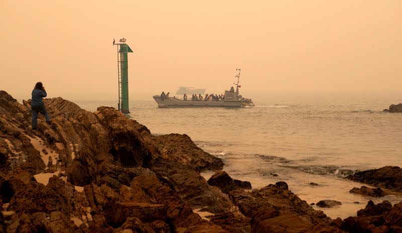 A supplied image obtained on January 3, 2020, shows bushfire evacuees aboard one of HMAS Choules' landing craft being ferried out the ship at Mallacoota