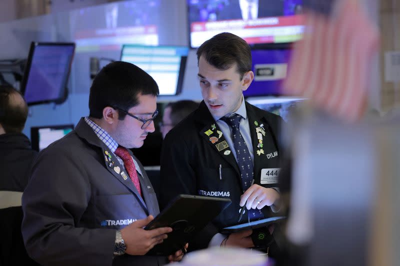 Traders work on the trading floor at the New York Stock Exchange (NYSE) in New York City