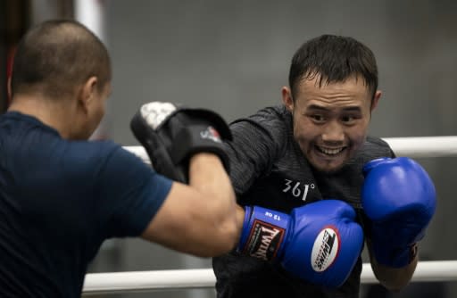 Zhang Fangyong "hits the mitts" during training at his Beijing gym