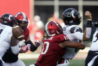 Cincinnati quarterback Jack Perry (10) fumbles as he is hit by Indiana's Ryder Anderson (10) during the first half of an NCAA college football game, Saturday, Sept. 18, 2021, in Bloomington, Ind. (AP Photo/Darron Cummings)