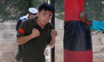 Chinese national Jack Wang a security trainer at the Chinese-run Deway Security Group leads Kenyan security guards in physical exercise during martial arts combat training at their company compound in Kenya's capital Nairobi, March 13, 2017. REUTERS/Thomas Mukoya