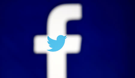 FILE PHOTO: A 3D-printed Facebook logo is displayed in front of the Twitter logo, in this illustration taken October 25, 2017. REUTERS/Dado Ruvic/Illustration/File Photo