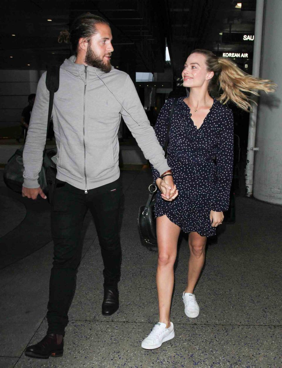 Margot Robbie and Tom Ackerley are seen at LAX on January 02, 2017 in Los Angeles, California
