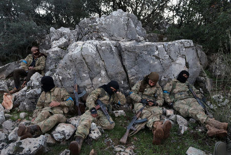 Turkish-backed Free Syrian Army fighters rest near the city of Afrin, Syria February 19, 2018. REUTERS/Khalil Ashawi