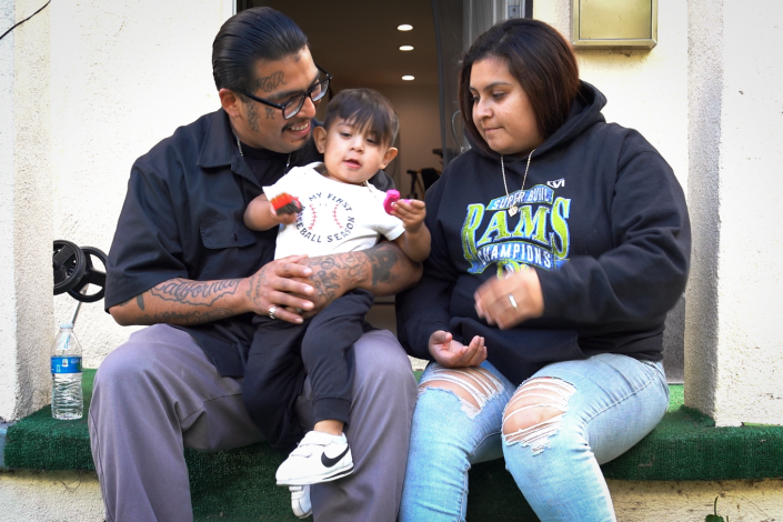 Jose Ruiz with his young son and his girlfriend at his mother's house.   (Jackson Hudgins / NBC News)