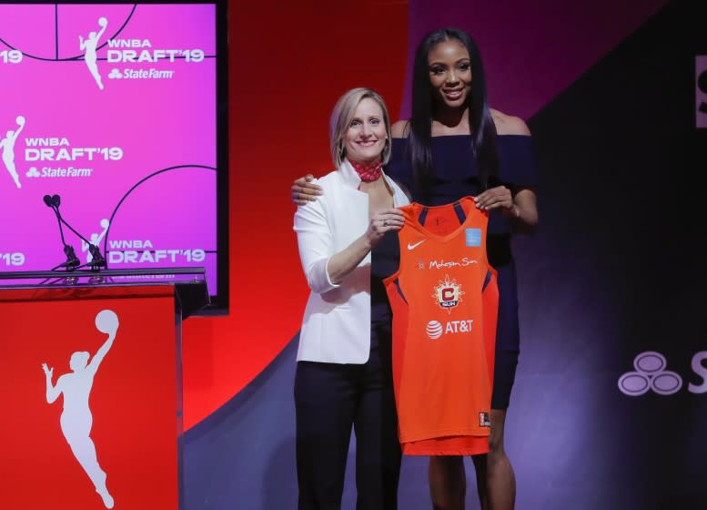 Kristine Anigwe, right, poses for a photo with WNBA COO Christy Hedgpeth after being selected by the Connecticut Sun as the ninth overall pick in the WNBA basketball draft Wednesday, April 10, 2019, in New York. (AP Photo/Julie Jacobson)