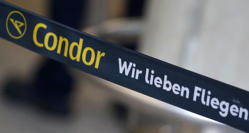 A banner reding "Condor we love flying" is seen next to a check-in counter of airline Condor at the airport in Frankfurt