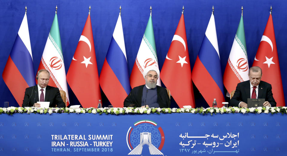 Russia's President Vladimir Putin, left, Iran's President Hassan Rouhani, center, and Turkey's President Recep Tayyip Erdogan attend a joint press conference in Tehran, Iran, Friday, Sept. 7, 2018. Putin, Erdogan and Iran's President Hassan Rouhani began a meeting Friday in Tehran to discuss the war in Syria, with all eyes on a possible military offensive to retake the last rebel-held bastion of Idlib. (AP Photo/Ebrahim Noroozi)