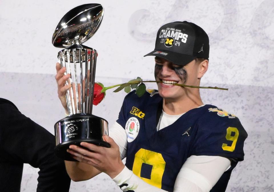 Michigan Wolverines quarterback J.J. McCarthy holds the Rose Bowl trophy after the wolverines defeated the Alabama Crimson Tide in the 2024 Rose Bowl college football playoff semifinal game at Rose Bowl.