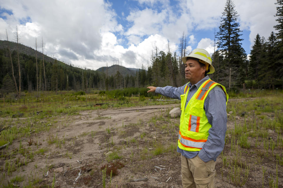 Daniel Denipah, Santa Clara Pueblo forestry director, shows the area where a pond used to be at the Santa Clara Canyon in northern New Mexico, Tuesday, Aug. 23, 2022. The canyon, part of Santa Clara Pueblo, is closed to the public while its habitat is restored after devastating wildfires and flash floods. (AP Photo/Andres Leighton)