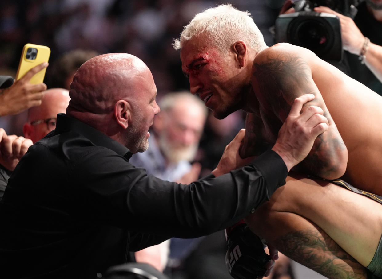 PHOENIX, ARIZONA - MAY 07: (R-L) Charles Oliveira of Brazil talks with UFC president Dana White after his submission victory over Justin Gaethje in the UFC lightweight championship fight during the UFC 274 event at Footprint Center on May 07, 2022 in Phoenix, Arizona. (Photo by Jeff Bottari/Zuffa LLC)