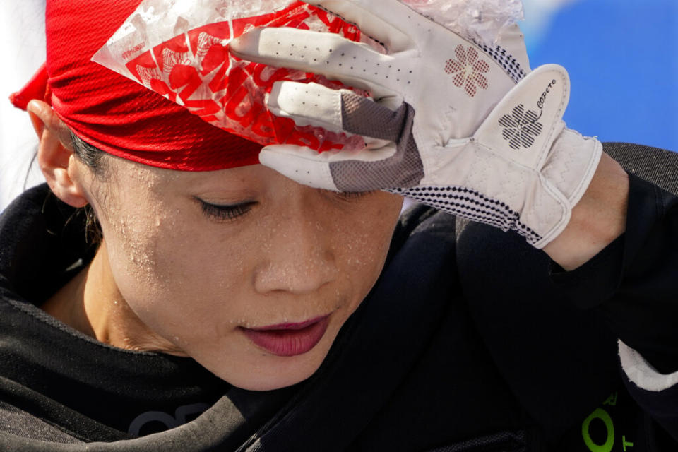 Beads of sweat gather on the face of China women's field hockey goalkeeper Dongxiao Li as she presses a bag of ice against her head during practice hours at the 2020 Summer Olympics in Tokyo, Japan on July 23, 2021.<span class="copyright">John Minchillo—AP Photo</span>