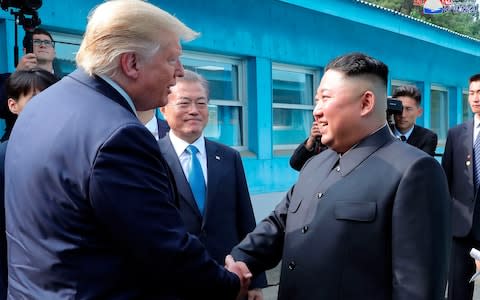 The trilateral greeting between the South and North Korean leaders and the US president was also unprecedented - Credit: HOGP/AP