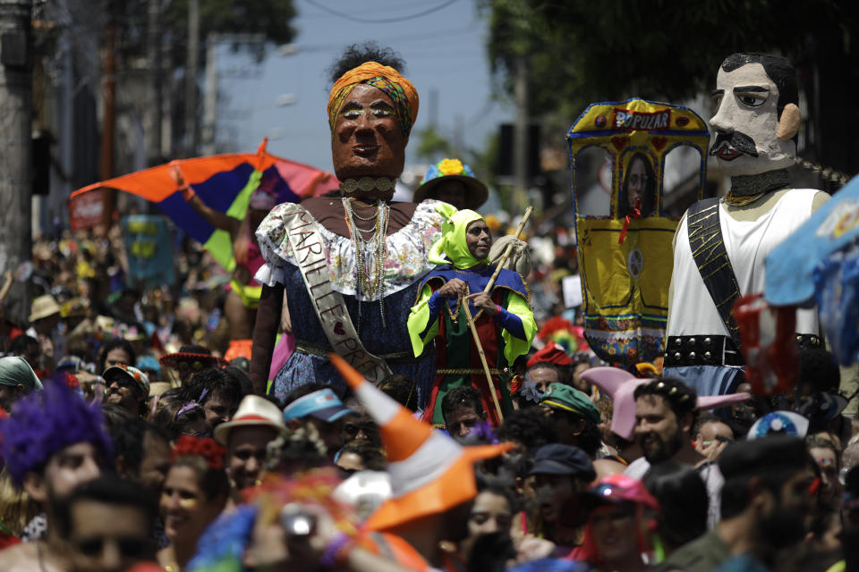Revelers perform next to a giant puppet depicting the slain councilwoman Marielle Franco during the "Ceu na Terra" or Heaven on Earth street party in Rio de Janeiro, Brazil, Saturday, Feb. 23, 2019. Merrymakers take to the streets in hundreds of open-air "bloco" parties ahead of Rio's over-the-top Carnival, the highlight of the year for many. (AP Photo/Leo Correa)