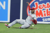 Los Angeles Angels center fielder Aaron Hicks (12) is late to catch a hit by Miami Marlins' Bryan De La Cruz (14) during the sixth inning of a baseball game, Wednesday, April 3, 2024, in Miami. The Angels defeated the Marlins 10-2. (AP Photo/Marta Lavandier)