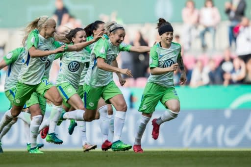 Wolfsburg players celebrate beating Bayern Munich in the German Cup final
