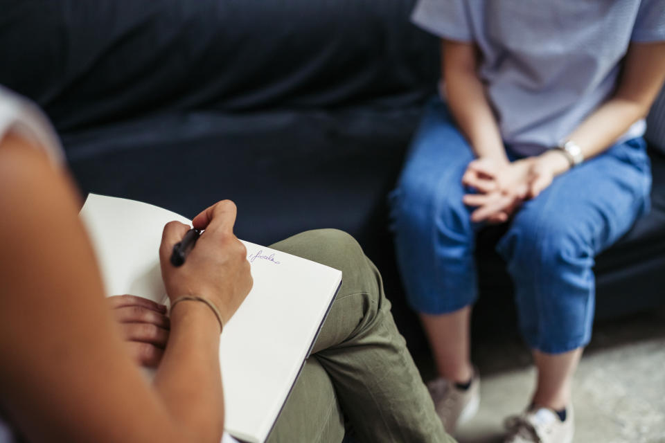 A person sitting in a therapist's office.