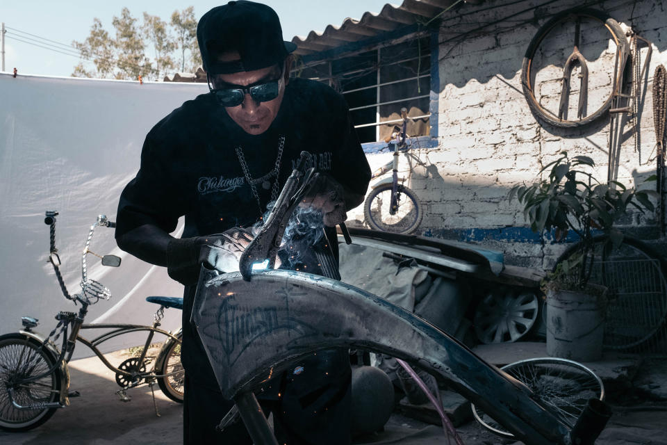 Royer, a member of Los Chilangos, works as an auto mechanic. He also builds various bike parts for other club members. Most of the bike parts are custom-made and bought on the internet from the US.