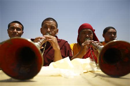 Buddhist monks offer prayer during the funeral rally of Nepali Sherpa climbers in Kathmandu April 21, 2014. REUTERS/Navesh Chitrakar