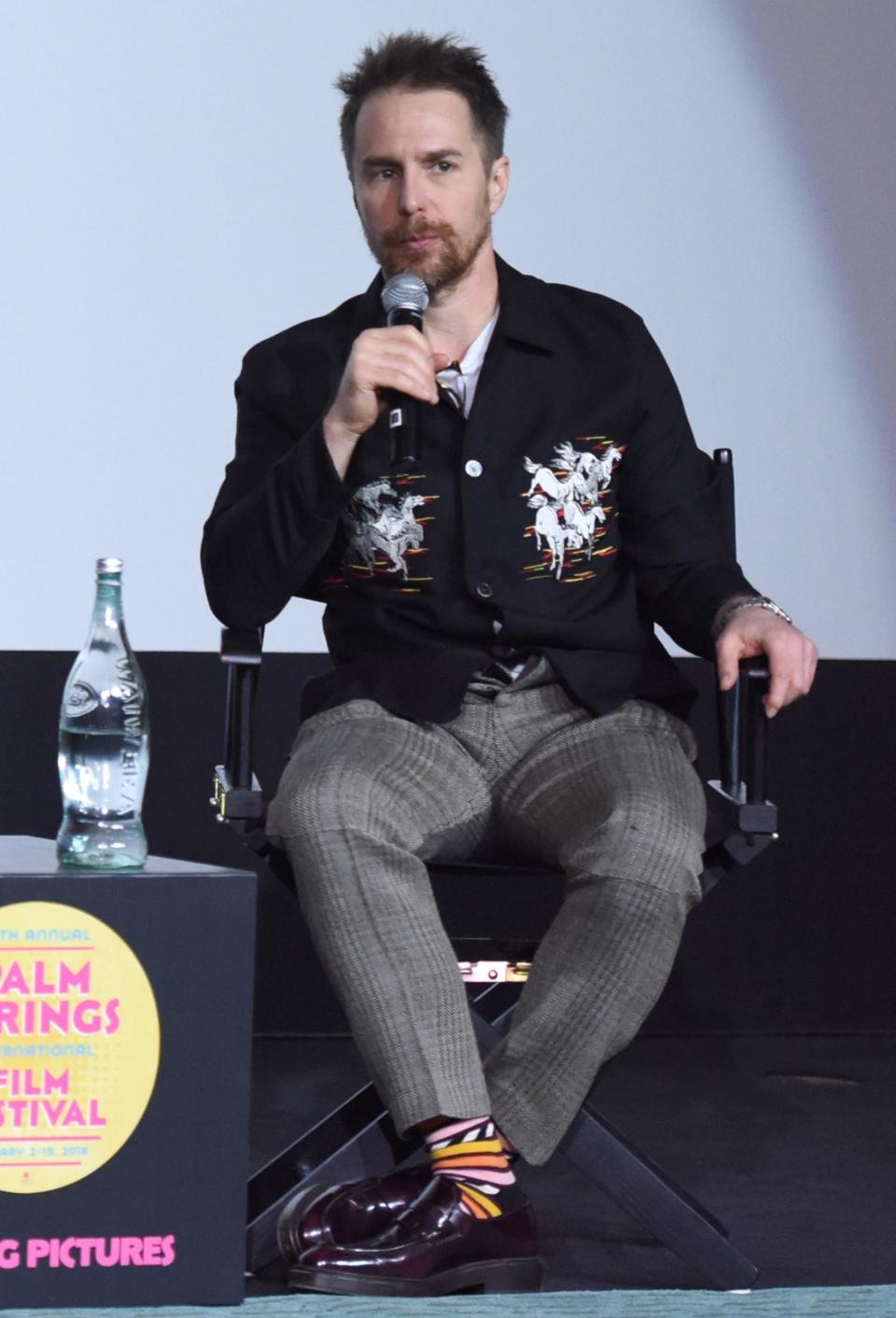 In an Our Legacy shirt, Stella McCartney pants, and Happy Socks socks at the Palm Springs International Film Festival on January 3, 2018