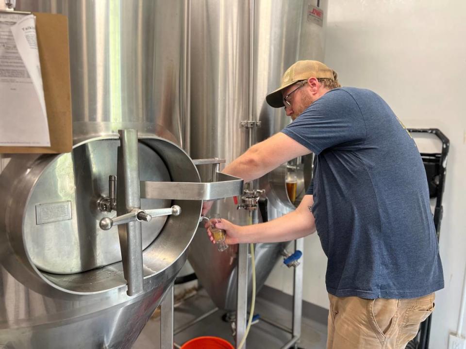 Brethren head brewer Kevin Whitehouse pours a taste of an IPA that’s been in the brew process for three weeks. This particular beer has a higher alcohol content than past versions the company has made.