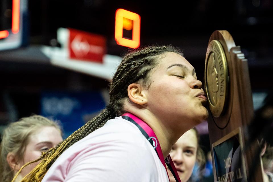 Bishop Garrigan's Audi Crooks (55) kisses the Class 1A Iowa girls state basketball championship trophy after defeating Newell-Fonda, on Saturday, March 4, 2023, at Wells Fargo Arena in Des Moines. 