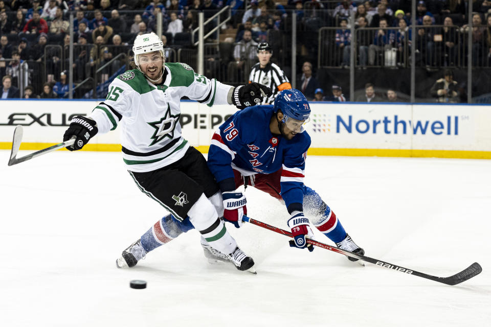 New York Rangers defenseman K'Andre Miller (79) and Dallas Stars center Matt Duchene, left, battle for the puck during the first period of an NHL hockey game on Tuesday, Feb. 20, 2024 in New York. (AP Photo/Peter K. Afriyie)