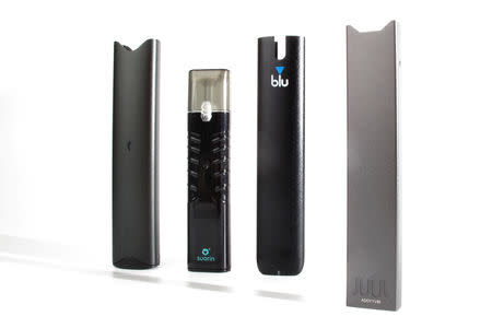 An electronic cigarette device made by JUUL (R) is shown next to other similar devices (L to R) Vuse Alto, Suorin ishare and myblu in this photo illustration taken September 20, 2018. REUTERS/Mike Blake/Illustration