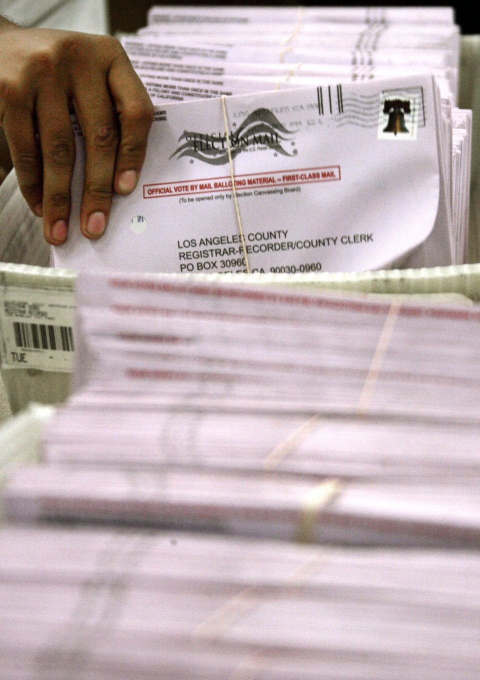 FILE - In this Tuesday, Oct. 28, 2008, file photo, mailed-in ballots are sorted and bundled, ready for counting at the Los Angeles County Registrar-Recorder's office in Norwalk, Calif. Over 100,000 mail-in ballots were rejected by election officials in California's March 2020 presidential primary, highlighting a glaring gap in the effort to ensure every vote is counted as a national dispute rages over the integrity of vote-by-mail elections. (AP Photo/Reed Saxon, File)