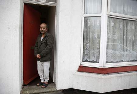 Iranian asylum seeker Mohammed Bagher Beyzevi poses for a photograph outside his home on Union Street in Middlesbrough, northern Britain, January 20, 2016. REUTERS/Phil Noble