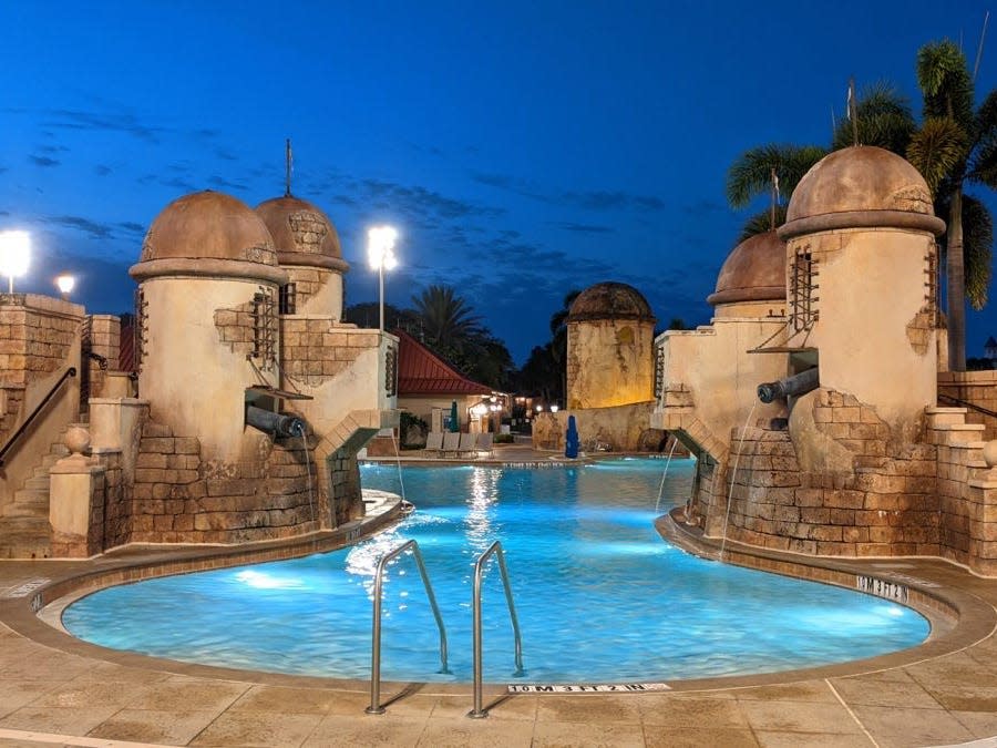 the pool at night at the caribbean beach resort at disney world