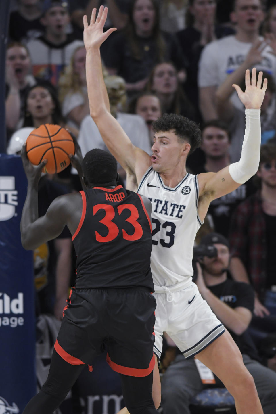 San Diego State forward Aguek Arop (33) looks to shoot as Utah State forward Taylor Funk (23) defends during the second half of an NCAA college basketball game Wednesday, Feb. 8, 2023, in Logan, Utah. (AP Photo/Eli Lucero)